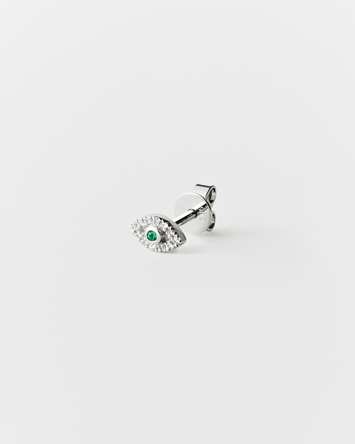 Eirene eye stud in 14k white gold, set with an emerald and natural diamonds.