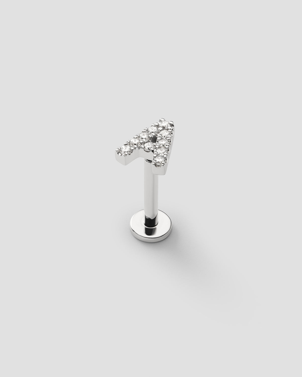 Letter labret in 14k white gold, detail view.