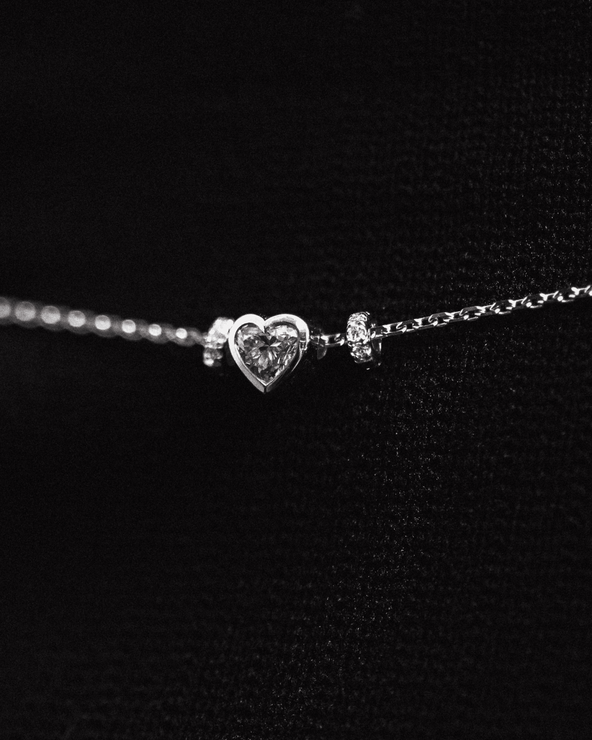 Erosia necklace with a 14k white gold charm on an 18k white gold chain, detail view.