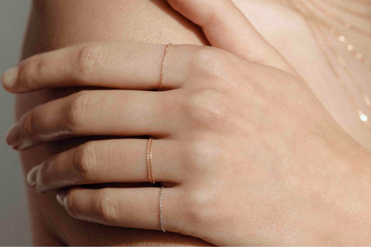 Layered chain necklaces in gold, photographed close up.