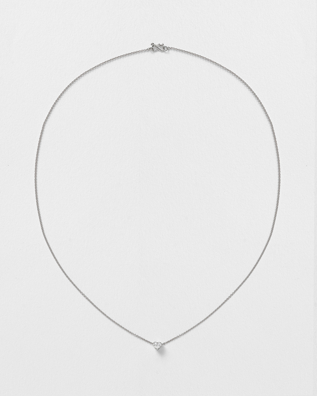 Erosia necklace with a 14k white gold charm on an 18k white gold chain.