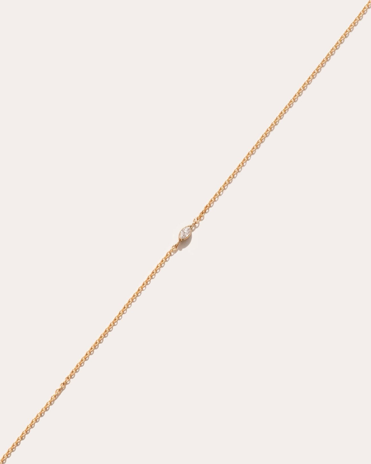 Andromis dot symbol in 14k yellow gold, set with a lab grown diamond, detail view.