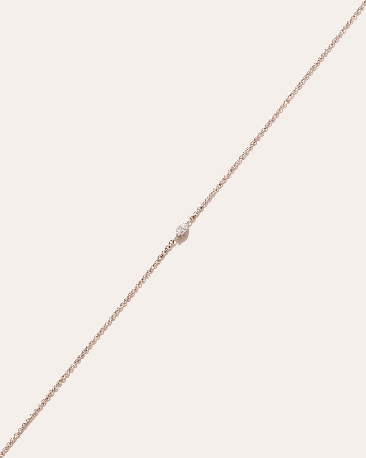 Andromis dot symbol in 14k white gold, set with a lab grown diamond, detail view.