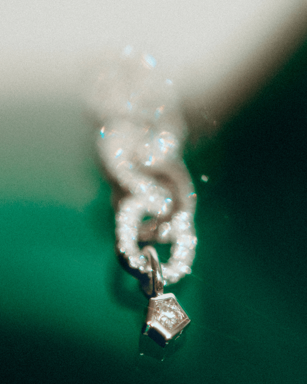 Echo link pendant in 14k white gold, set with a natural diamond, detail view.