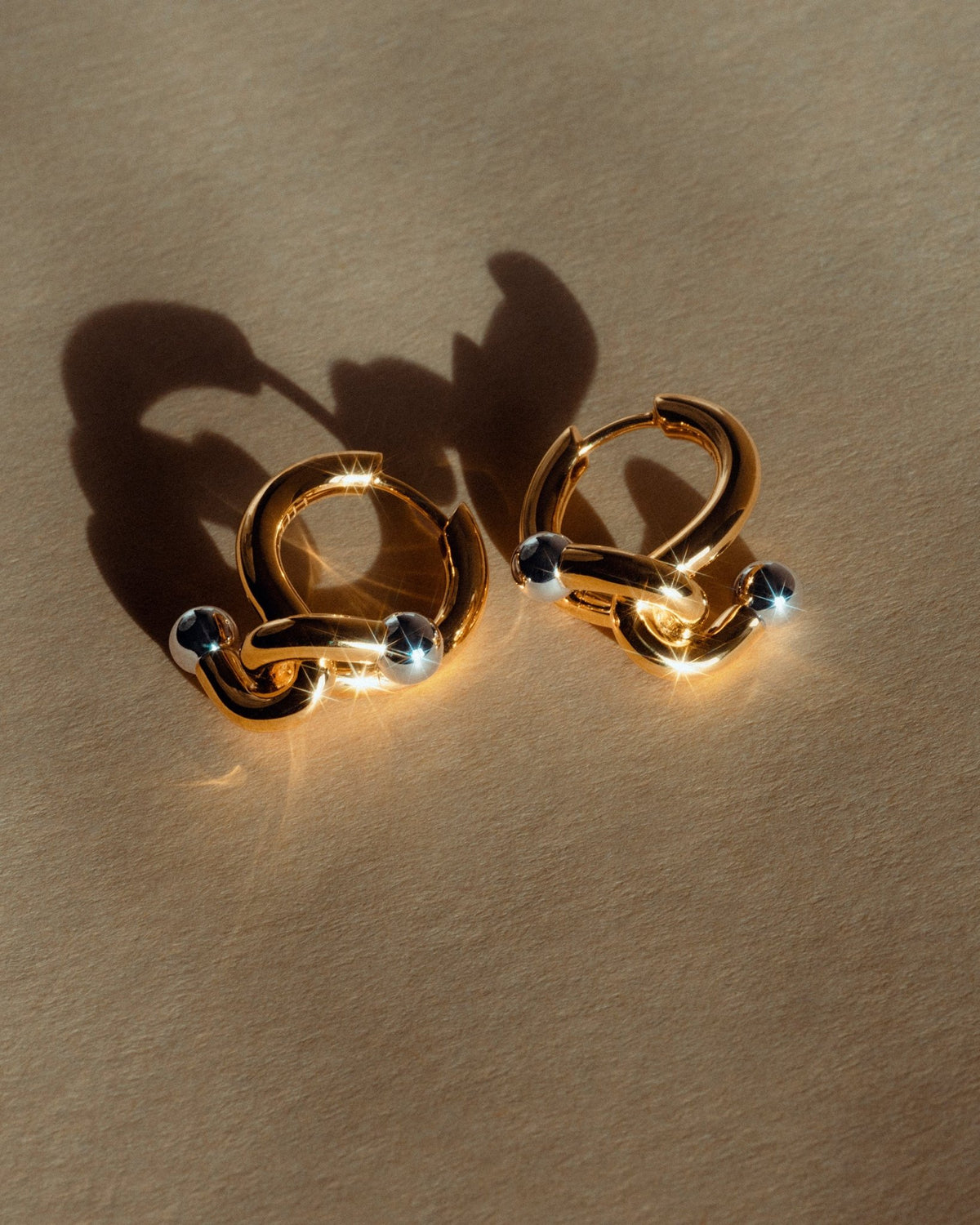 Falcat earring in 925 silver, shown on the ear.