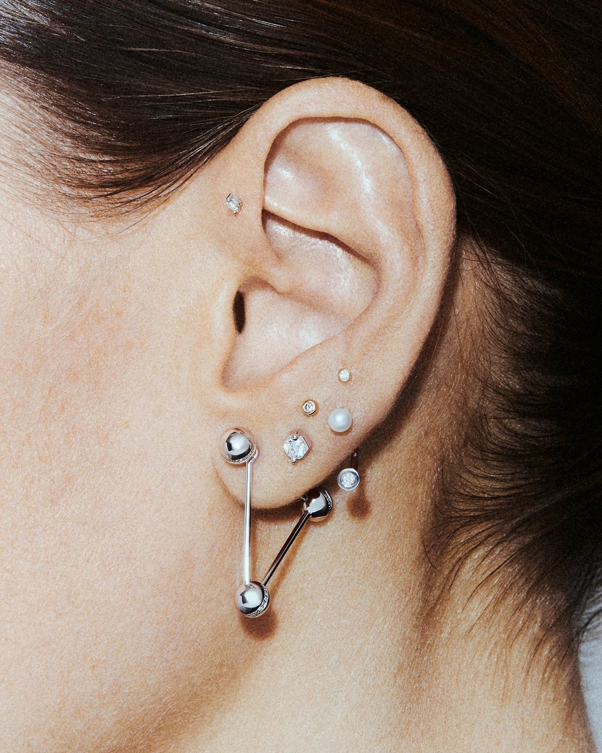 Triangle ear pin, shown worn.