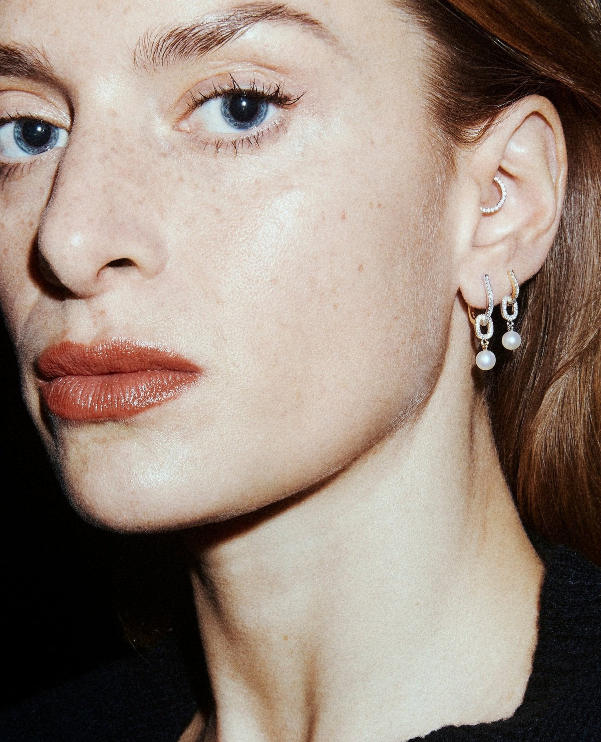 Diamond clicker in 14k yellow gold, set with a natural diamond, shown on the ear.