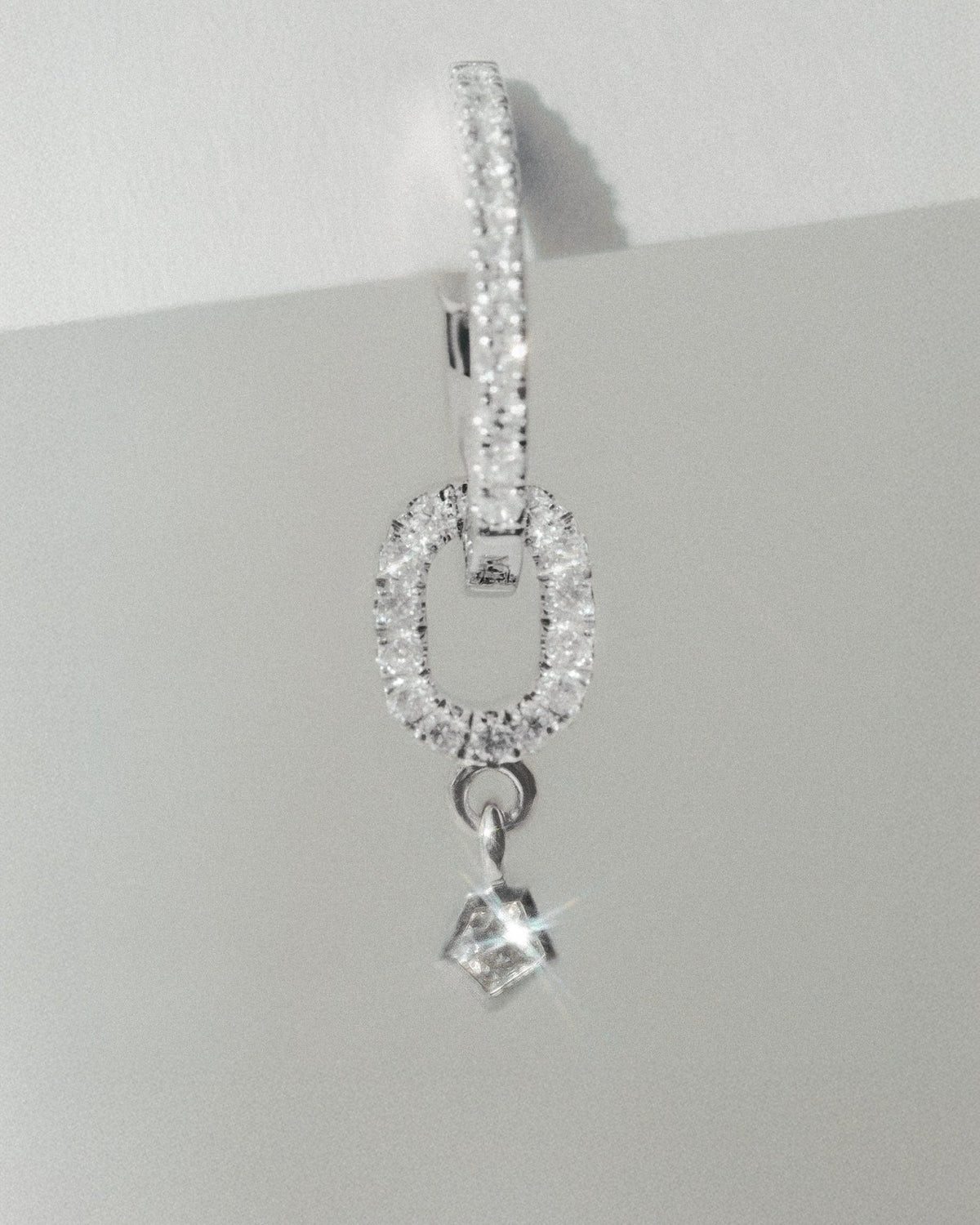 Echo pendant in 14k white gold, set with a natural diamond, detail view.
