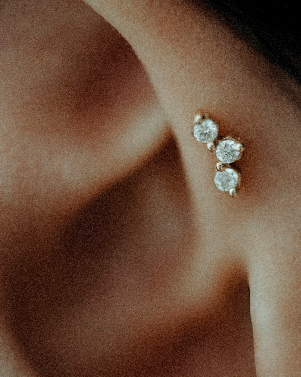 Close-up of an ear wearing the Honey labret.
