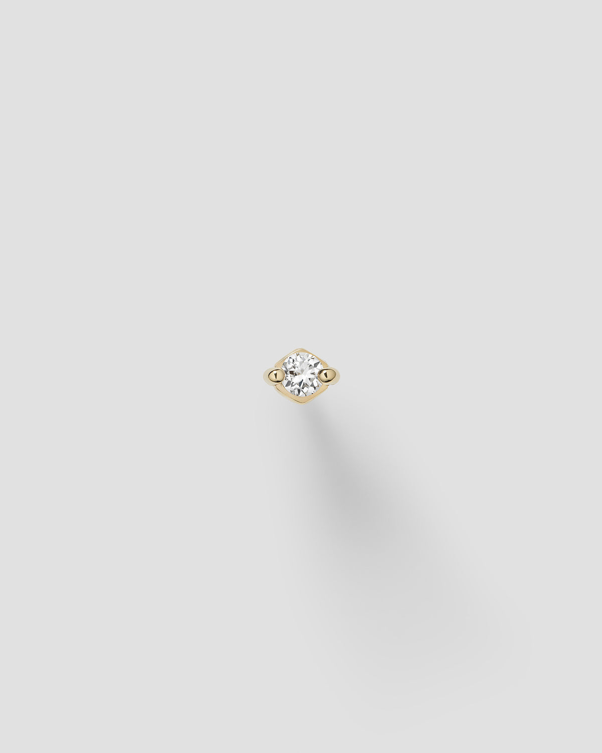 Ivory labret in 14k yellow gold.