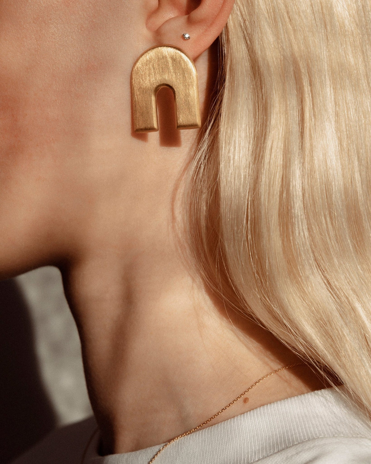 Iris Arch studs, shown worn.