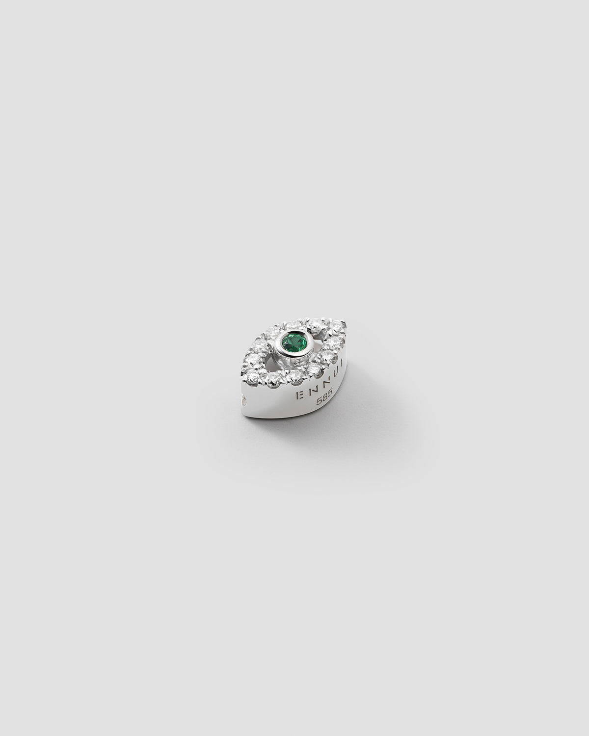 Eirene eye charm in 14k white gold, set with an emerald and lab grown diamonds, detail view.
