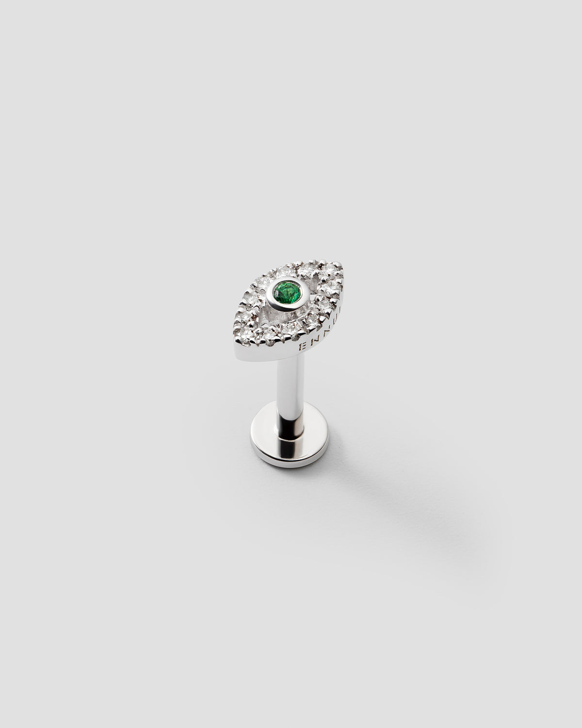 Eirene eye labret in 14k white gold, set with an emerald and natural diamonds, detail view.