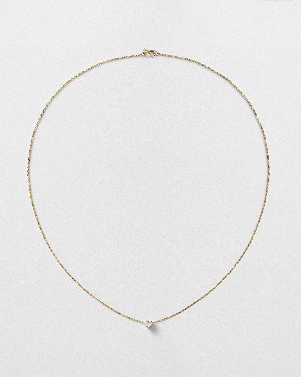 Erosia necklace with a 14k yellow gold charm on an 18k yellow gold chain.